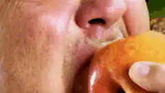 Man biting into a red apple