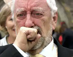 Old man crying and wiping tears