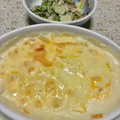 Baked pasta with melted cheese and salad