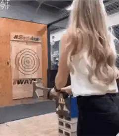 Woman throws axe and falls over