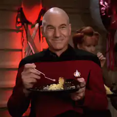 Captain Picard eating with a fork
