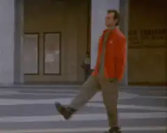 Man in orange jacket doing a high kick