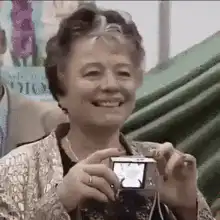 Old lady takes a photo with a flash
