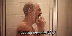 Man sobbing uncontrollably in shower