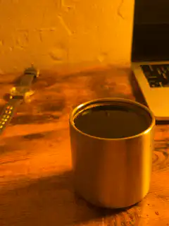 metal cup on wooden desk
