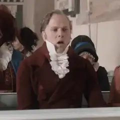 Man in period costume spits out food