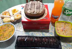 table with cake, soup, pastries, and drinks
