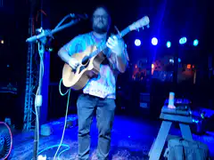 Man playing acoustic guitar on stage