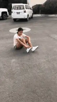 Woman tying shoe in parking lot