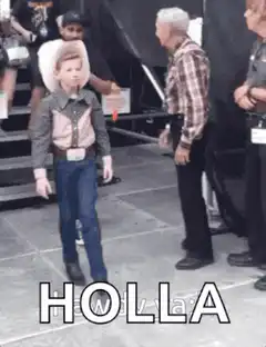 Young boy in cowboy hat dancing