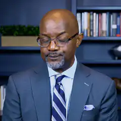 Man in suit opens eyes