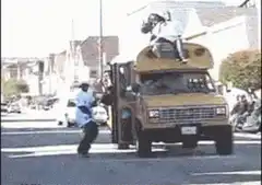 People dancing on a yellow school bus