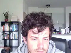 Man with curly hair looking down