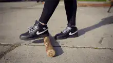 Woman hits baseball bat on ground