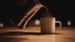 Pouring hot coffee into a mug