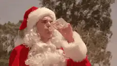 Santa Claus drinking from a bottle