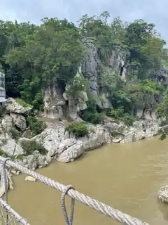 View from a rope bridge over a muddy river