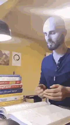 Bald man stressed studying books