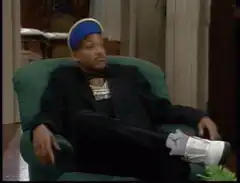 Will Smith sitting in chair shrugging