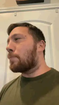 Man turns head to look at camera