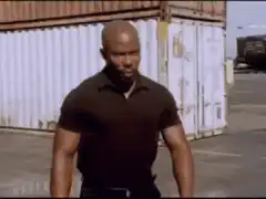 Michael Jai White and John Travolta stare down