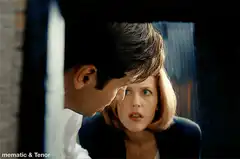 Clarice and Hannibal peeking around a corner