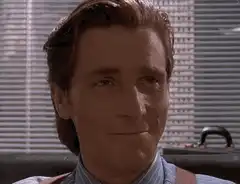 Gary Oldman smirking and smiling