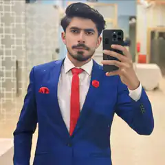 Man in blue suit taking mirror selfie