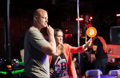 Woman holding bitcoin in club