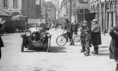 Vintage car drives down street