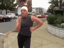 Man jogging and smoking on sidewalk