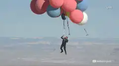 Man flying with balloons
