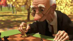 Old man playing chess in park