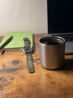 watch and coffee on desk