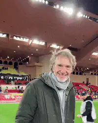 Man in stadium smiling and pumping fist