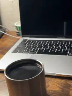 coffee cup in front of laptop