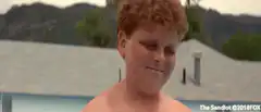 Boy splashes girls with water balloon