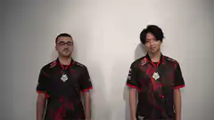 Two men in jerseys do a fist bump and high five