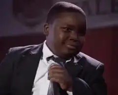 Young boy in suit smirking