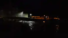 Dark river at night with buildings