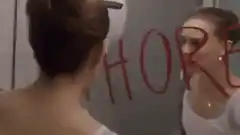 Woman erases whore from mirror