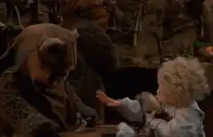 Baby Yoda offers food to a creature