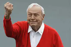 Old man in red sweater raising fist