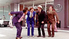 Men in suits jumping in the street