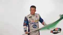 NASCAR driver waves green flag