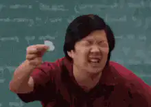 Ken Jeong holding a condom