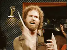 Jim Gaffigan holding a knife and cup