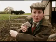 Woman in flat cap gives thumbs up