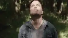 Man looks up then closes eyes