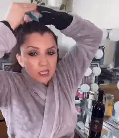 Kourtney Kardashian tying her hair